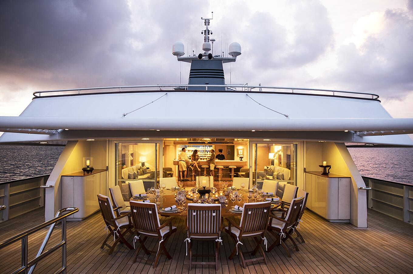Outdoor dining at sunset aboard an Aqua Blu yacht in Raja Ampat.
