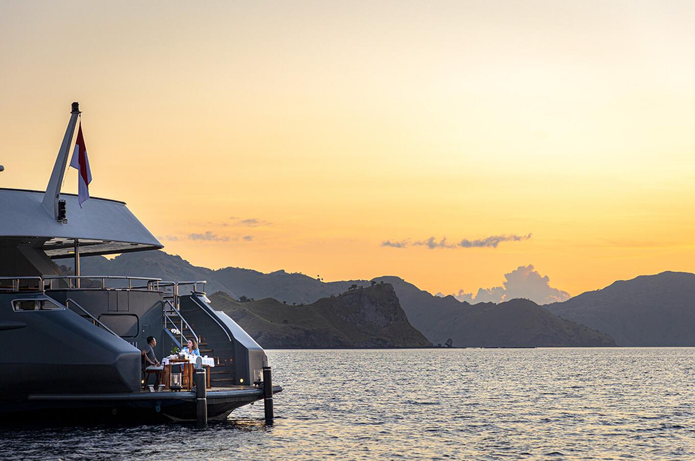Romantic private dining aboard an Aqua Blu yacht in Raja Ampat.