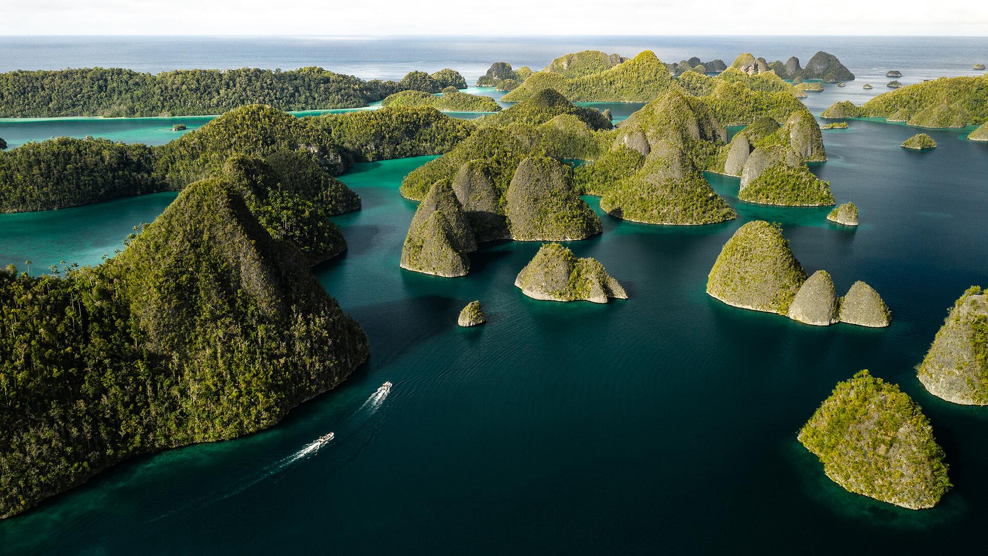 Aerial view of Raja Ampat's limestone islands and turquoise lagoons in West Papua, Indonesia.