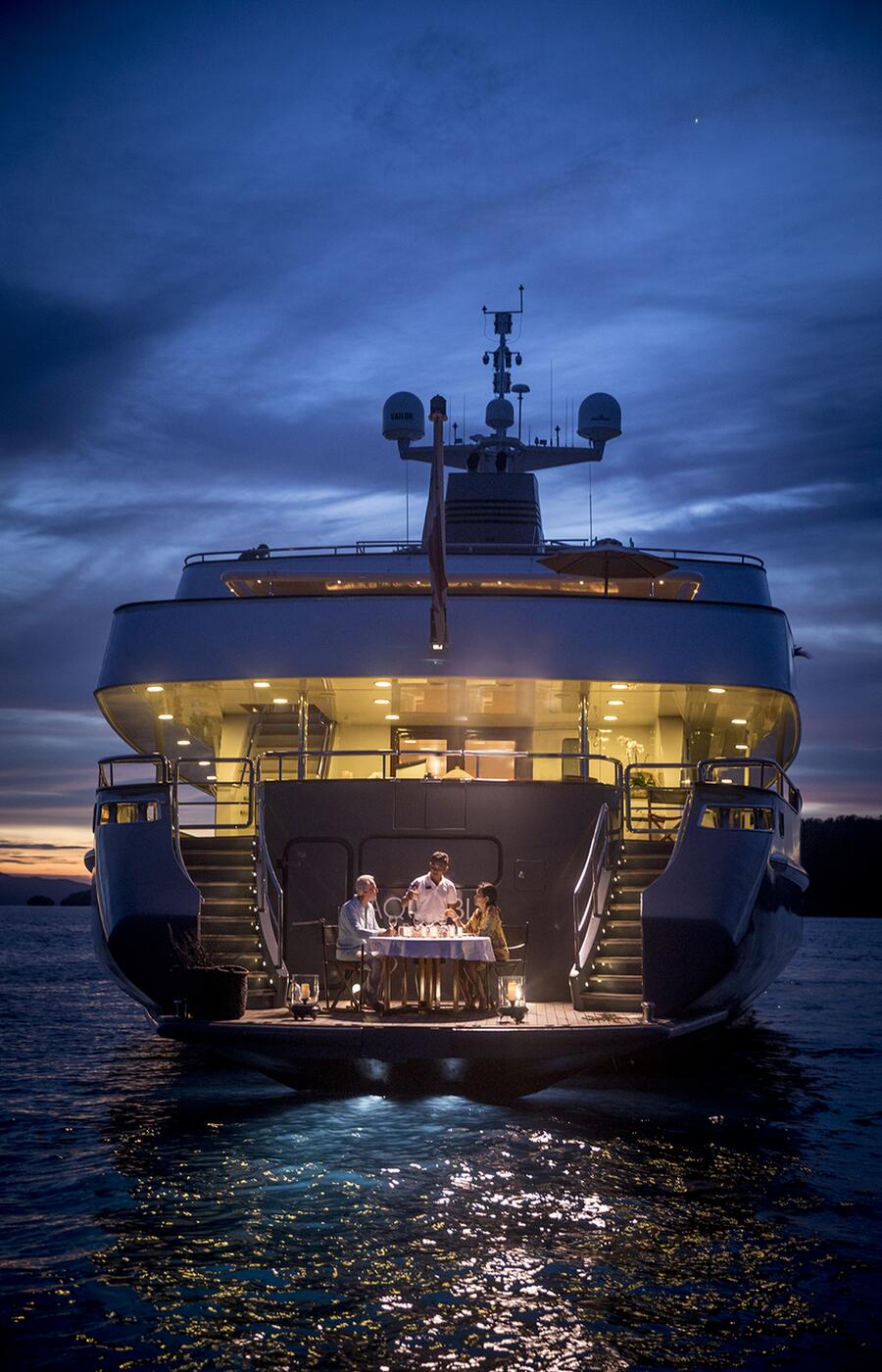 Romantic dinner setting aboard an Aqua Blu yacht in Raja Ampat.